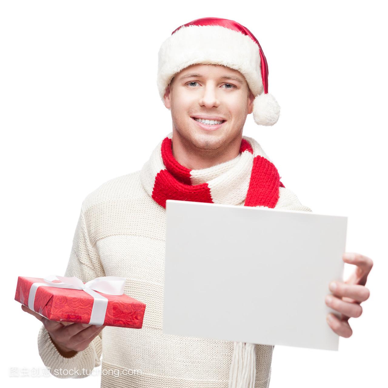 休闲的年轻人,在圣诞老人的帽子牵标志和圣诞