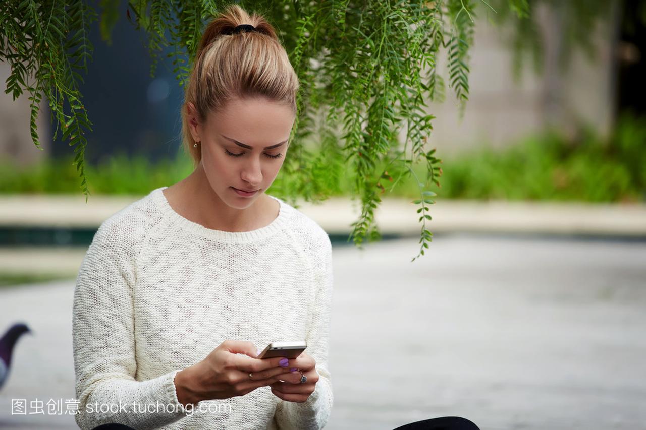 Woman chatting with classmate via cell phone