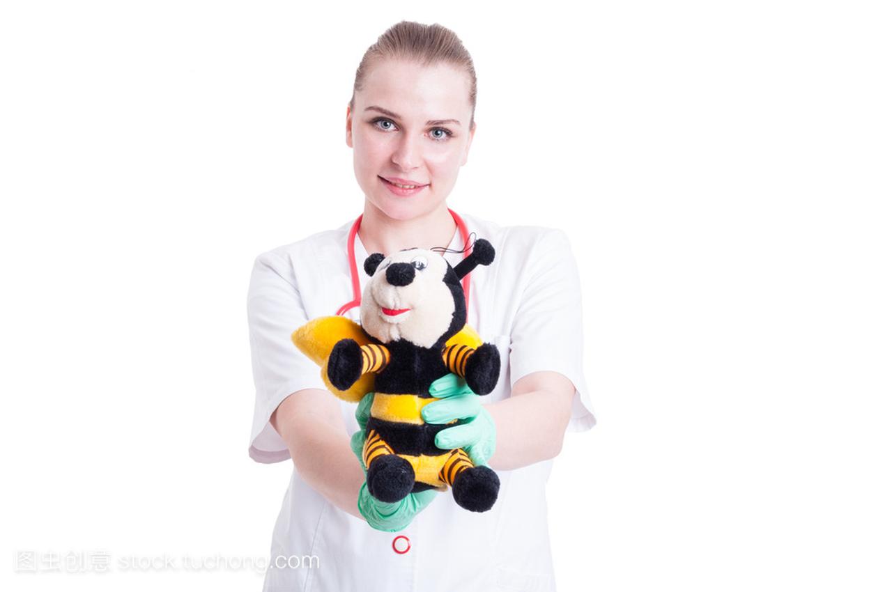 Young pediatrician holding a fuzzy plush toy and