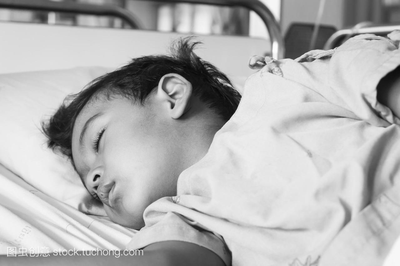 Little asian boy sick sleep on the patient bed in