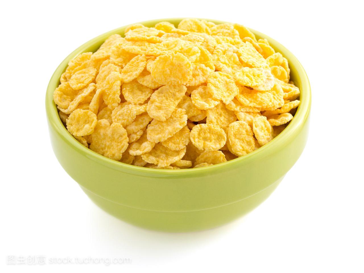 Corn flakes in bowl on white