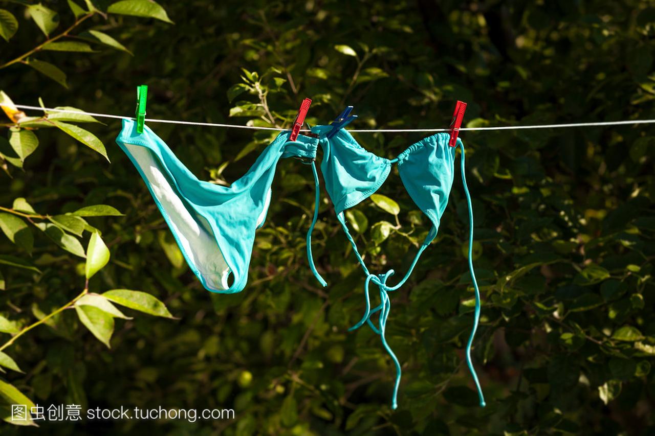 在花园的晾衣绳干燥的女式泳衣