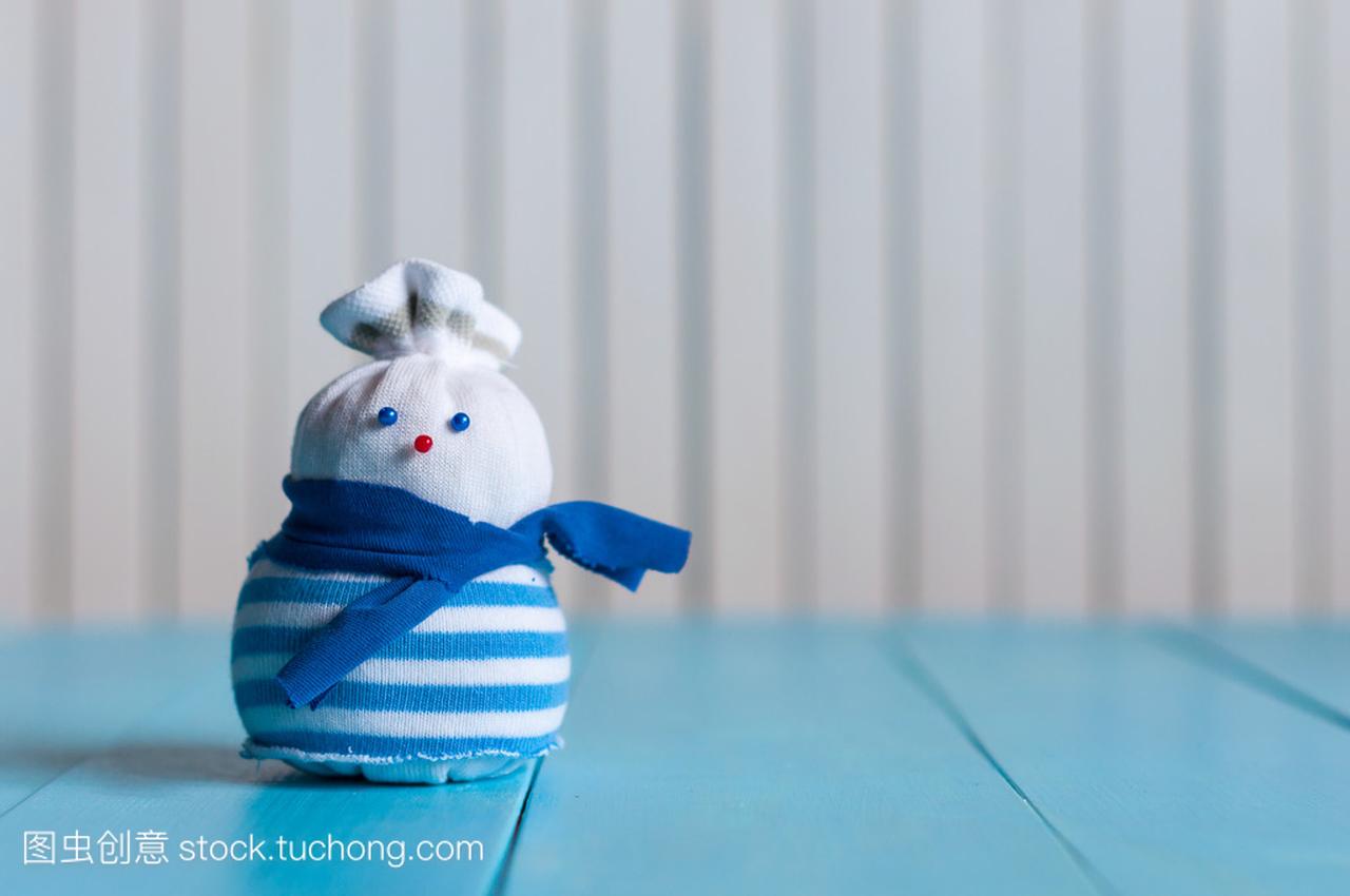 Funny little handmade snowman in a blue stripy