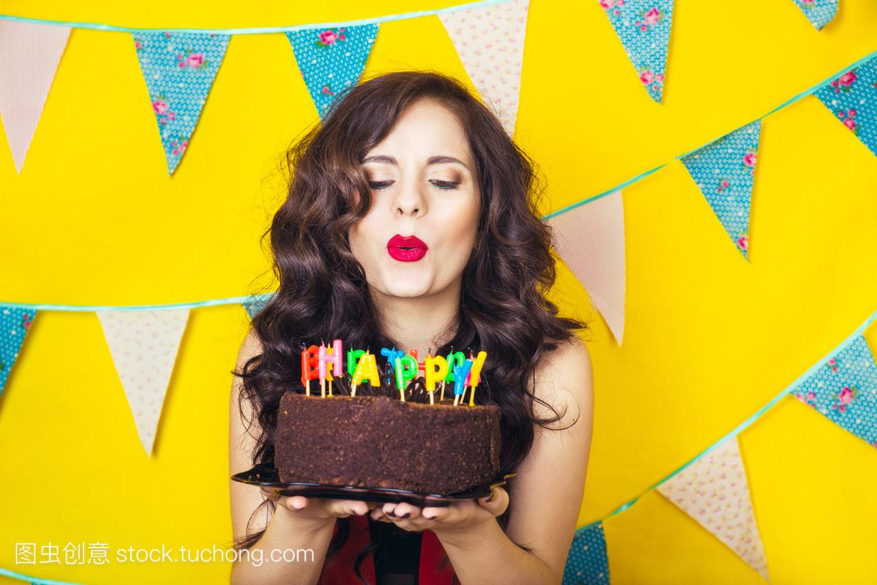 Beautiful caucasian girl blowing candles on her