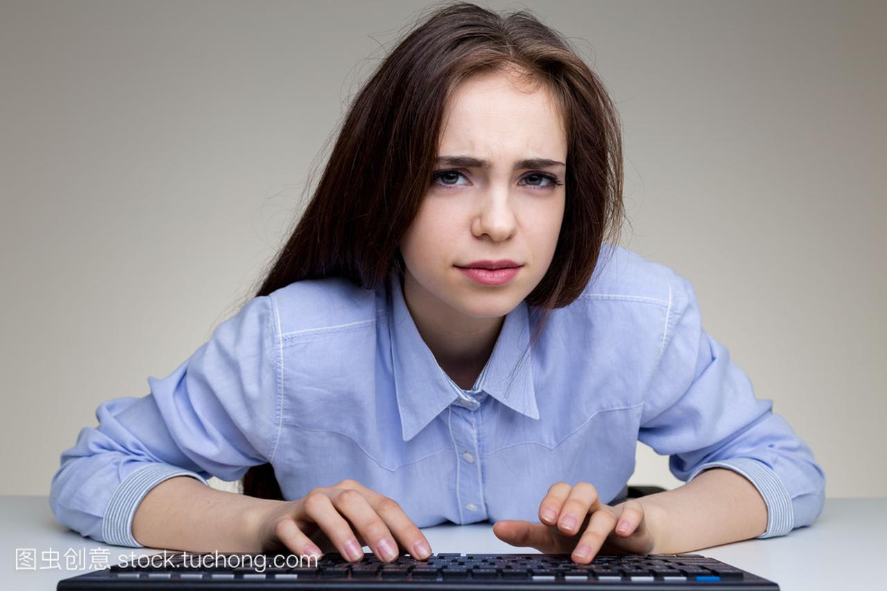 Frowning woman using keypad