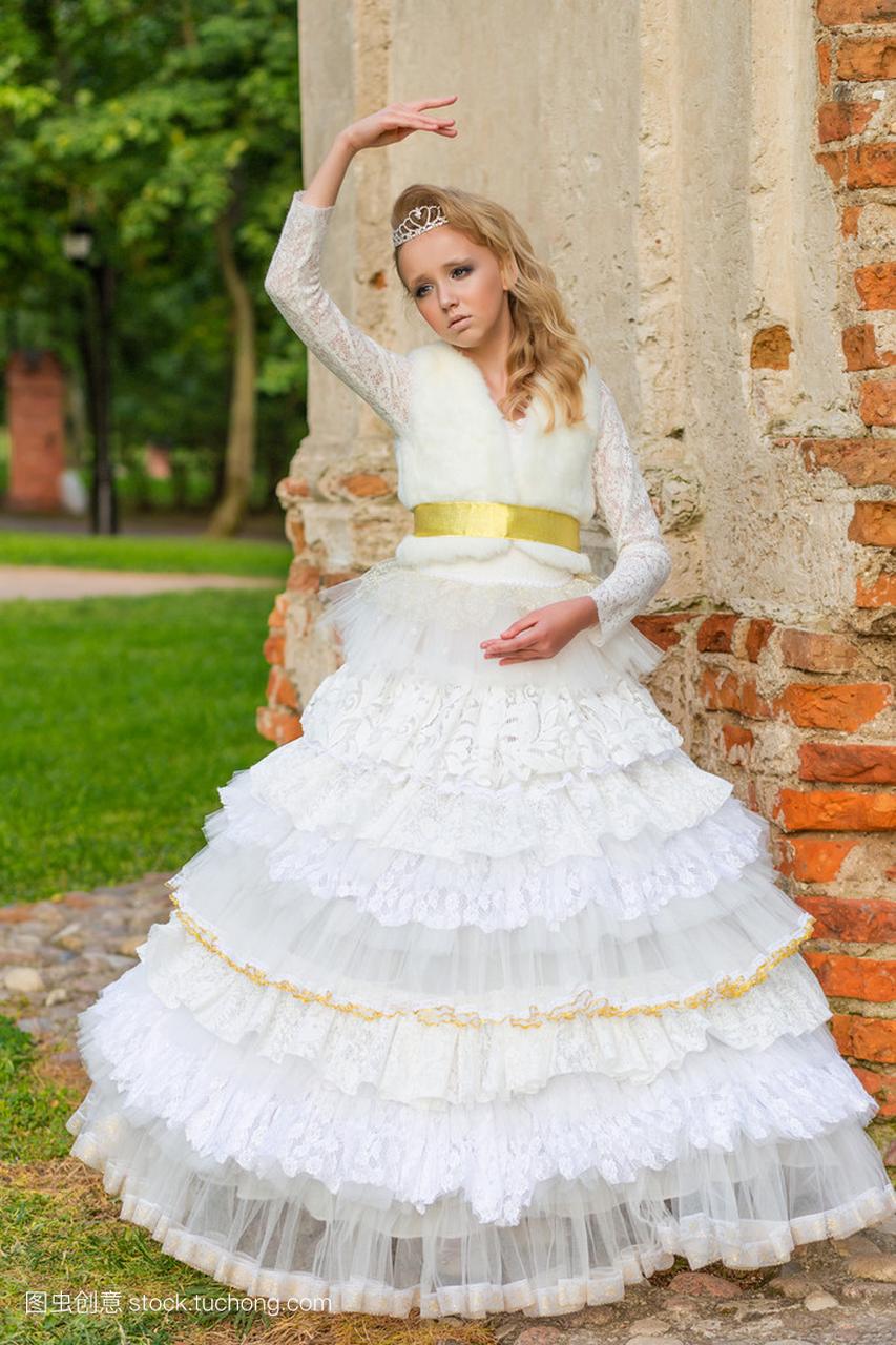年轻女孩在漂亮的白色连衣裙的时尚照片