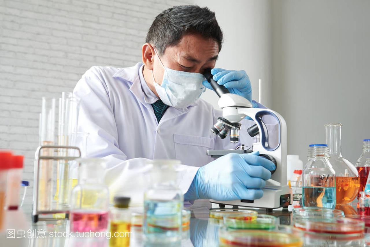 Scientist working with microscope in modern la