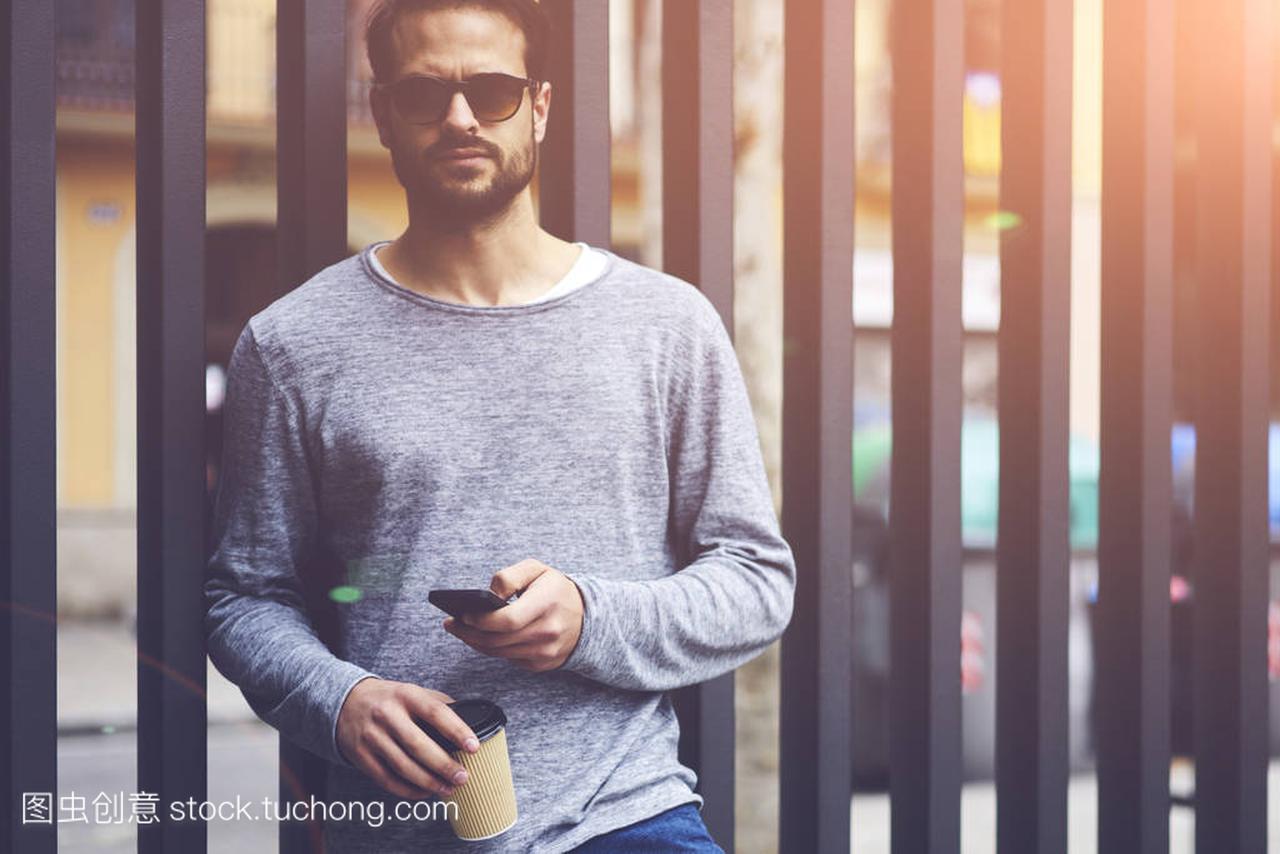 earded man with trendy sunglasses chatting on