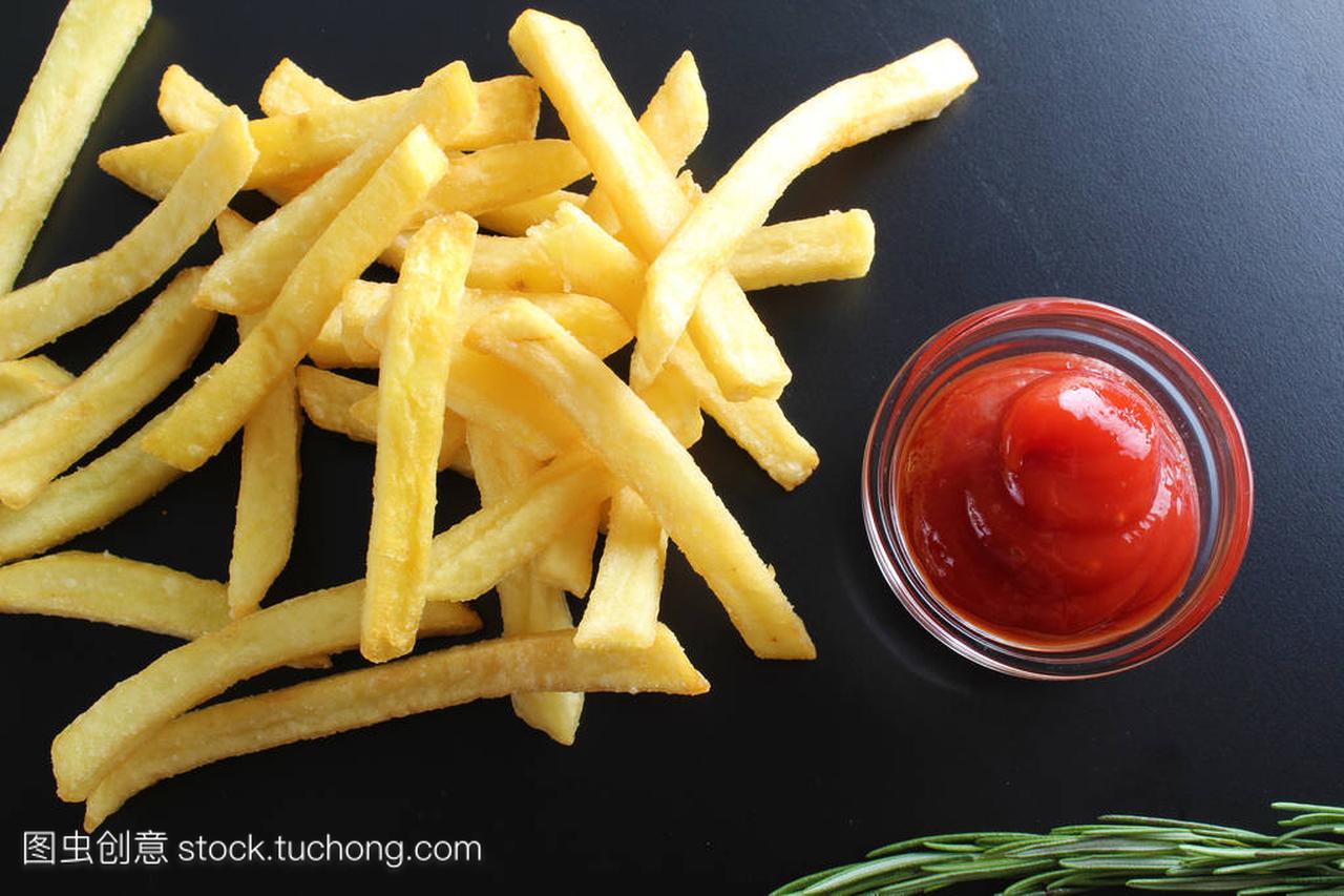 french fries and ketchup on a dark background