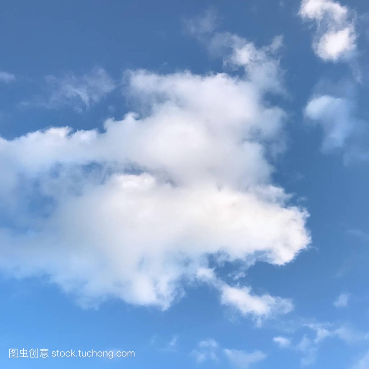 Innocent blue sky with white fluffy clouds