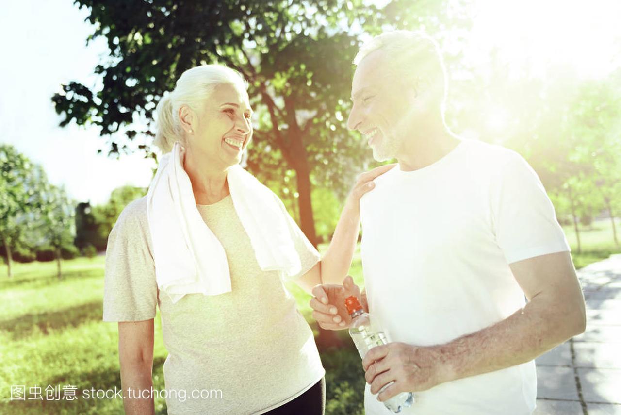 hing couple. Pretty senior couple standing in a p