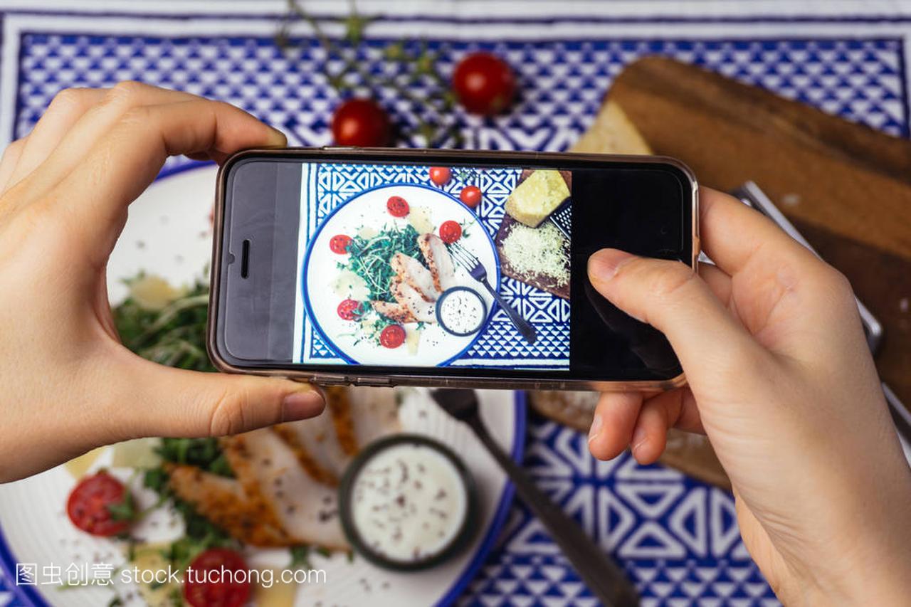 Food photography: the girl is taking a photo of C