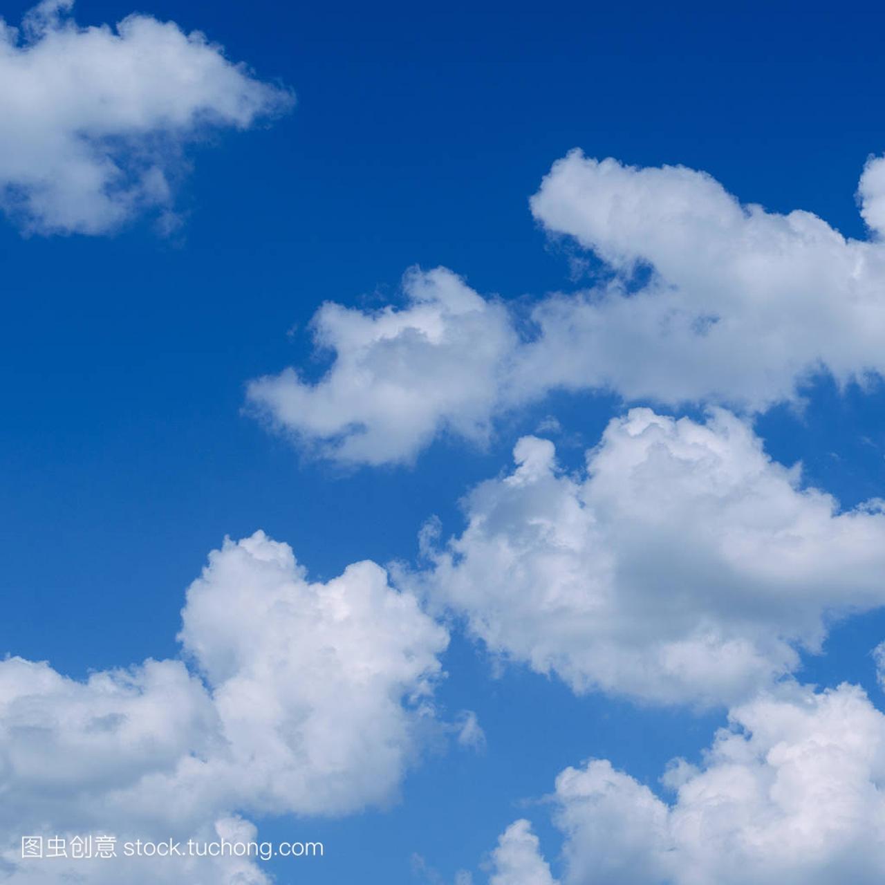 White fluffy clouds in the vast blue sky. Abstract