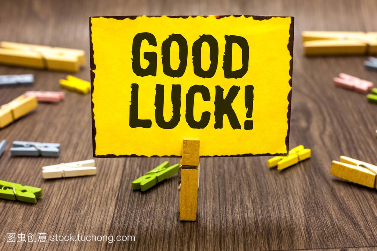Text sign showing Good Luck. Conceptual photo A positive fortune or a happy outcome that a person can have Clothespin holding yellow paper note several clothespins wooden floor