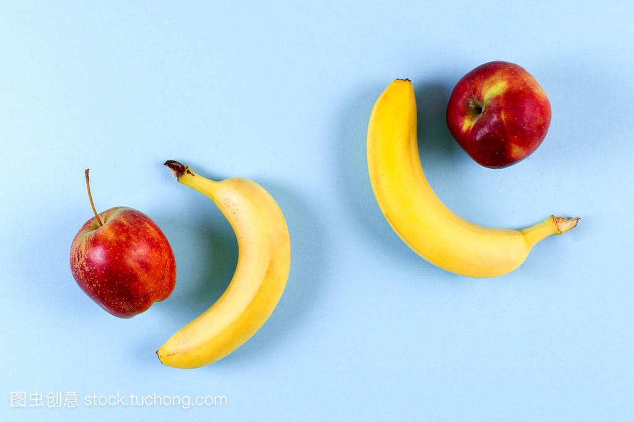 symmetrical apples and bananas on a blue bac