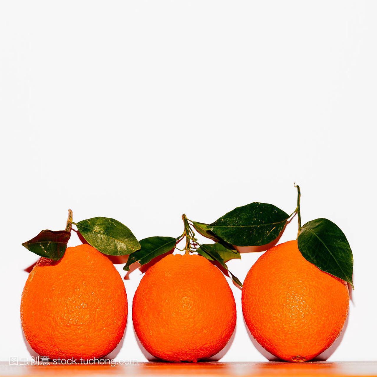 Fresh Oranges on a white wall background