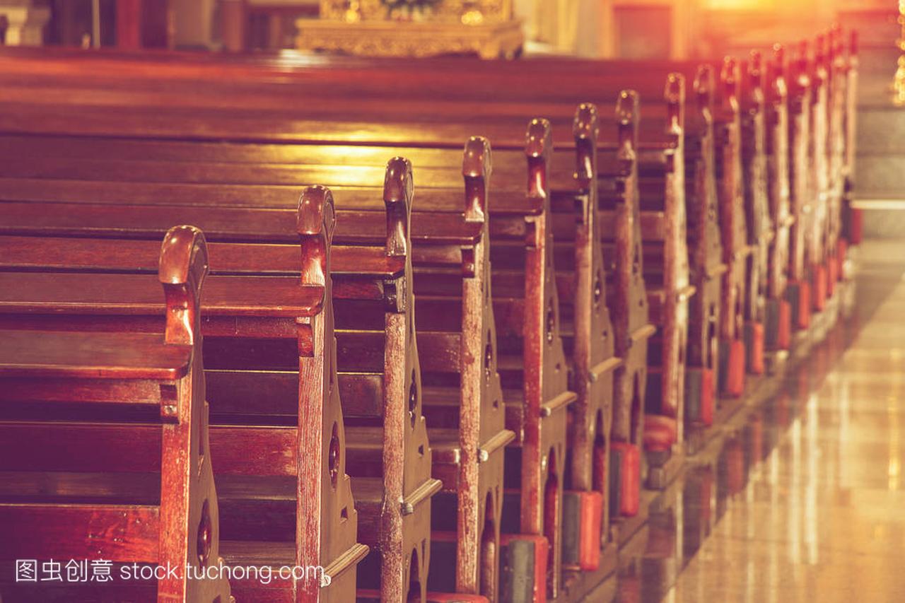 rows of empty old wooden pews in historic chur