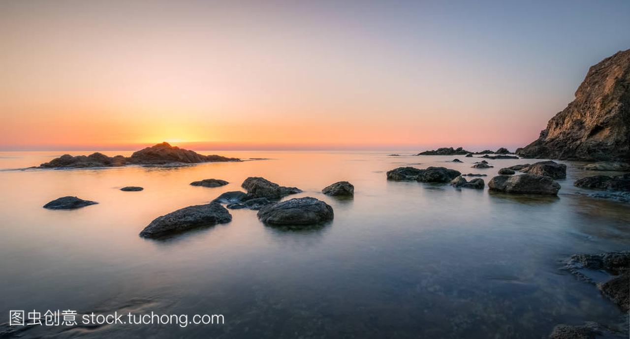 Rocks bathed by the calm sea