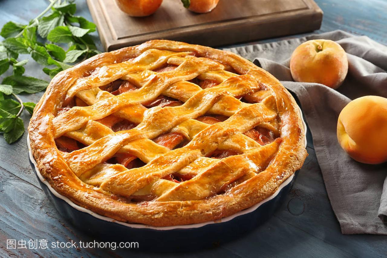 Delicious peach pie on wooden table