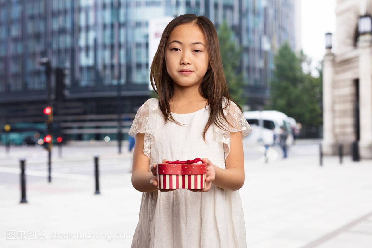 chinese little girl holding a gift