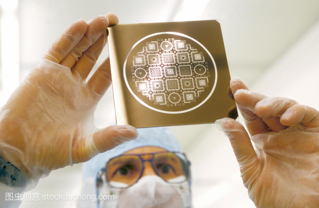 术员手持硅片掩膜,用于制造mems微电子机械系